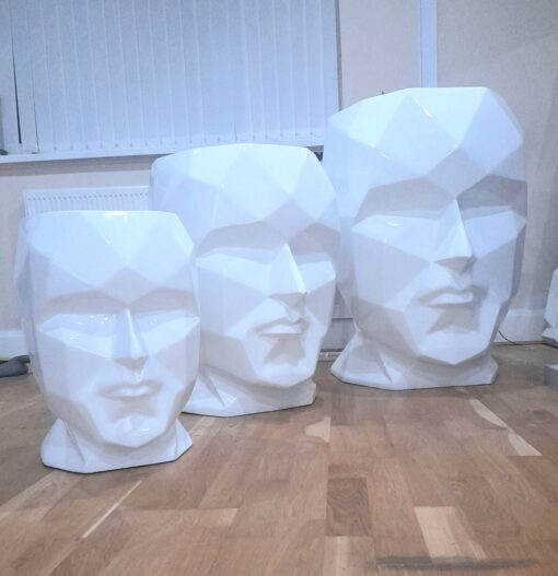 collection of talking heads fiberglass planters