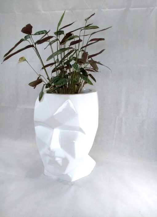 large white head fiberglass planter with plant on top