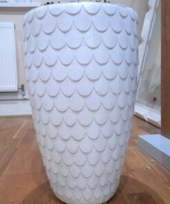 fiberglass planter that looks like it has feathers on it