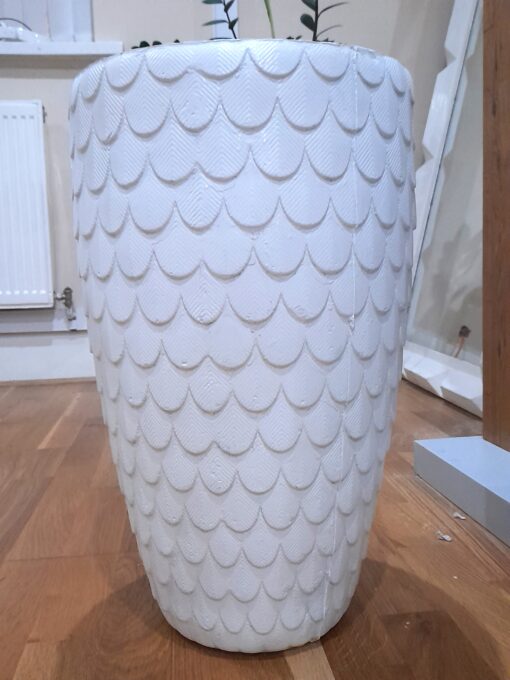 fiberglass planter that looks like it has feathers on it